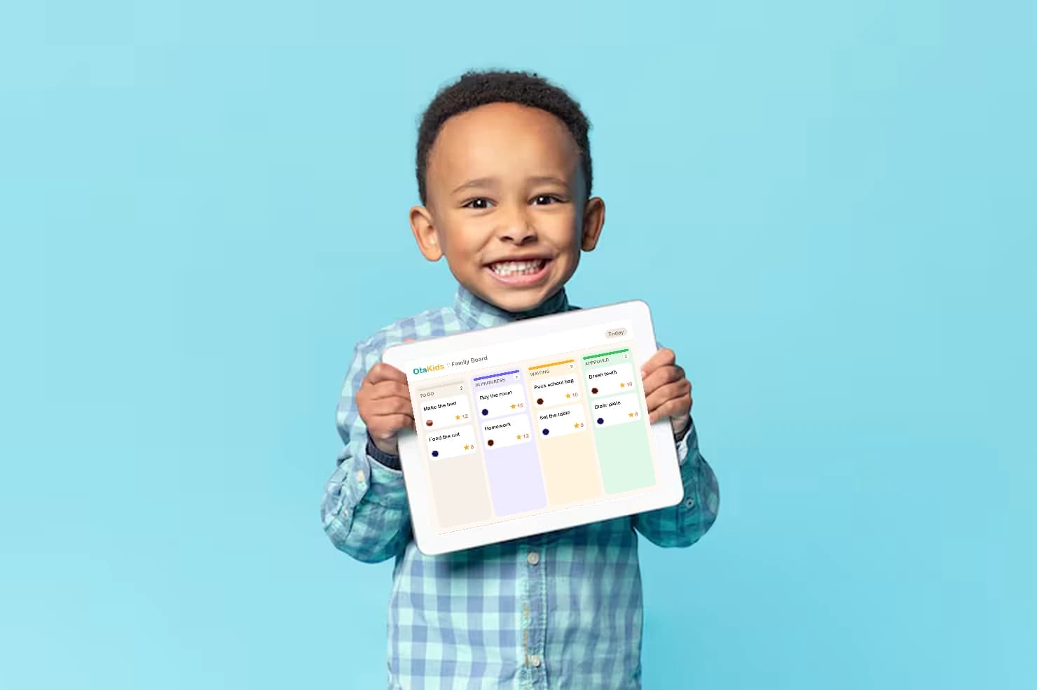 A happy kid showing off the Otakids family board on the kitchen tablet